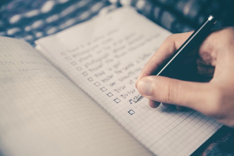 A checklist and pen on a workbench